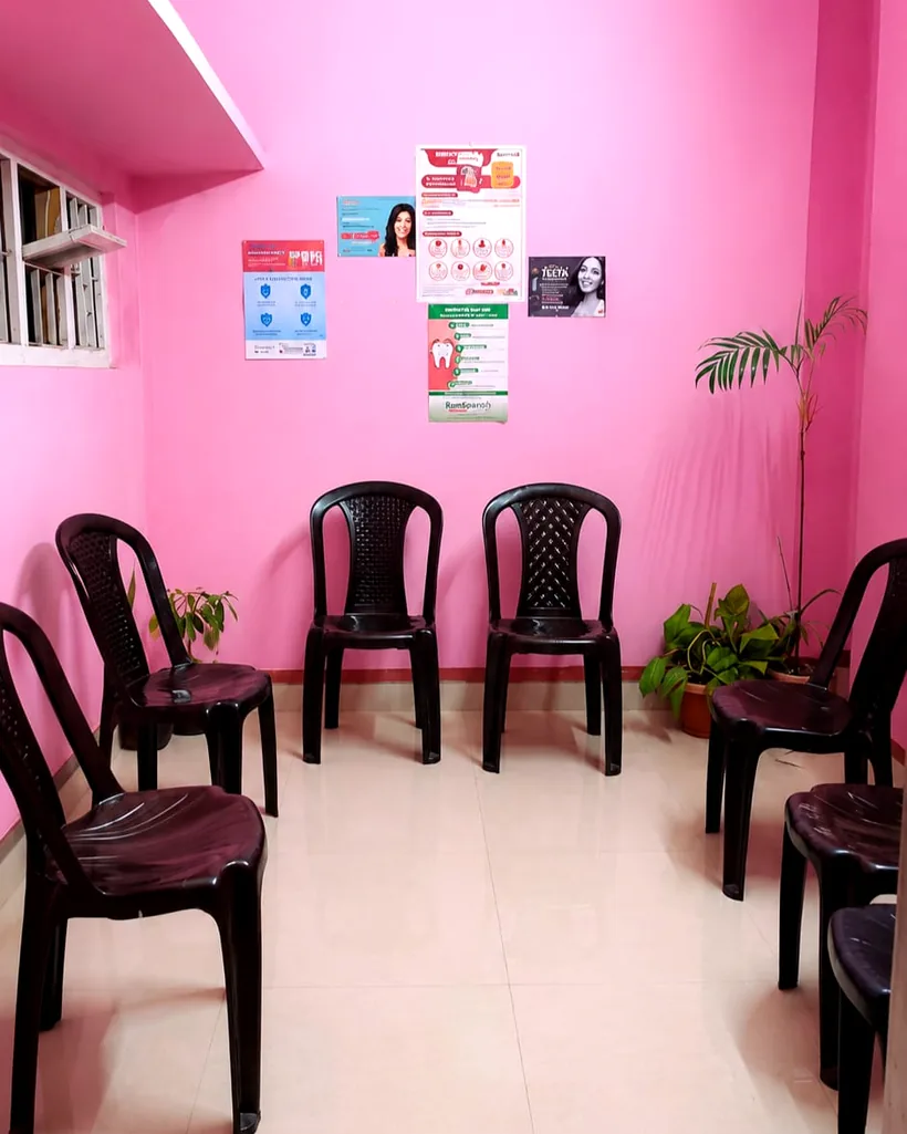 The bright pink waiting room with rows of chairs