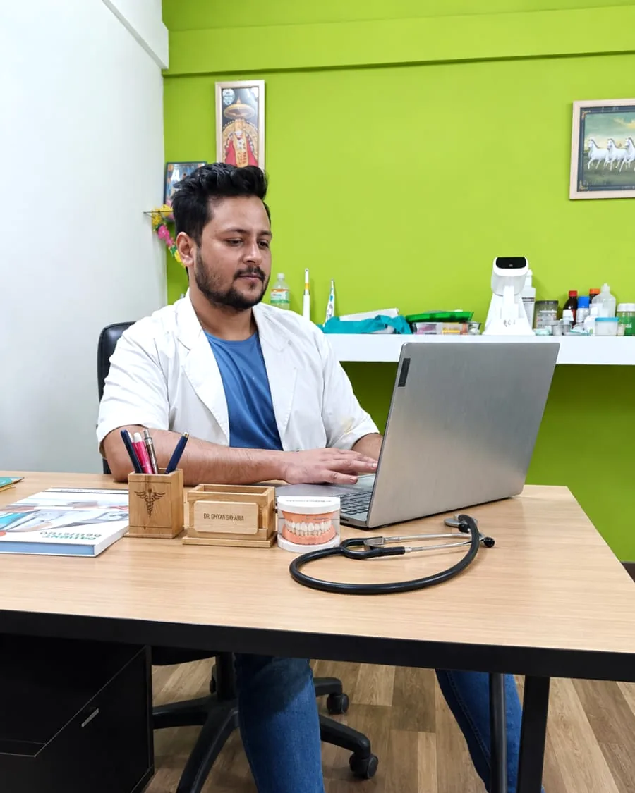Dr. Dhyan Saharia at his desk in the clinic